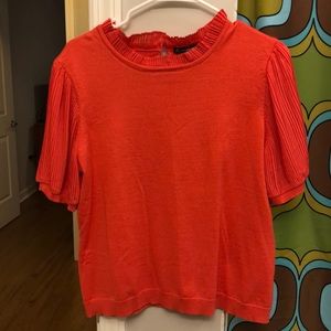 Coral (orange pink) blouse with ruffled trim and sleeves